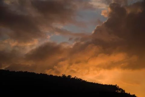 Mountain sunset with colourful clouds Stock Photos