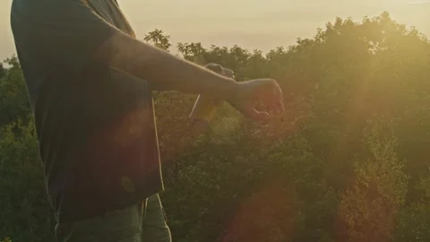 Mountain Sunset: Man Spraying Mosquito Repellent Stock Footage 280394874