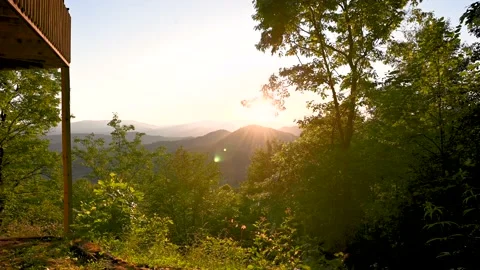 A Mountain Sunset Next to a Cabin Stock Footage 137866193