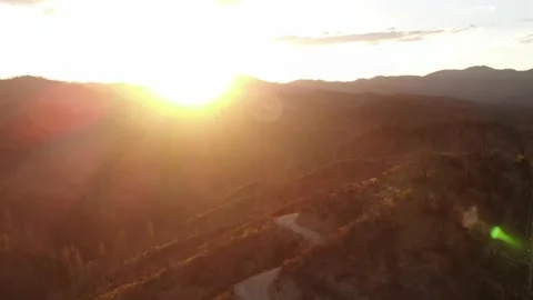 Mountain sunset over dirt road in recent wildfire area Stock Footage 221447425