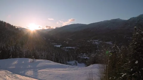 Mountain sunset over ski hill, Whistler, snow, forest. 4K 24FPS Stock Footage 303729924