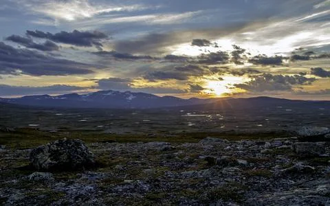 Mountain Sunset Panorama with Dramatic Clouds and Rocky Wilderness Stock Photos