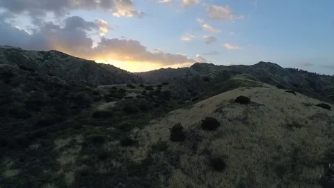 Mountain with sunset sky -  pull back Stock Footage 77662872