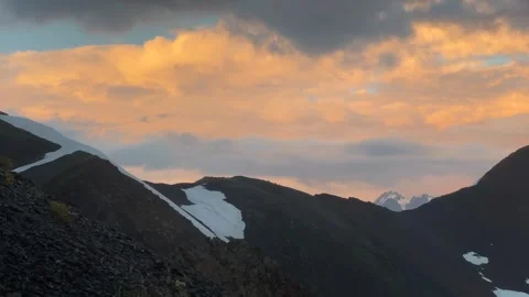 Mountain sunset spreading in wide view over dark ridges Stock Footage 343770680