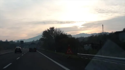 Mountain sunset sunrise shot from moving vehicle on highway Stock Footage 252148306