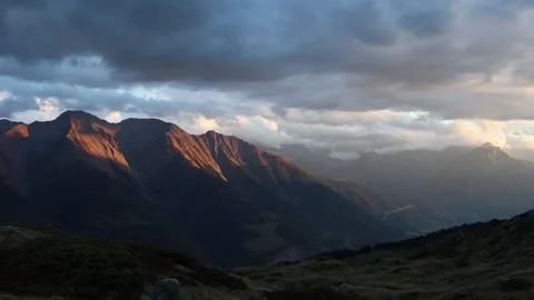 Mountain sunset in Swiss alps, warm evening golden light Stock Footage 318338192