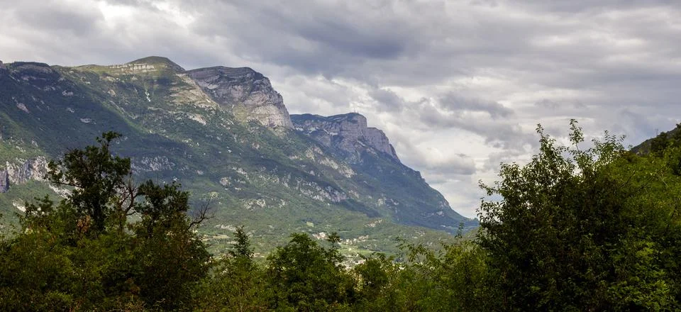 A mountain surrounded by clouds Фото