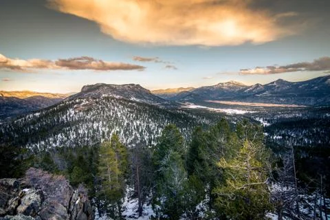 A mountain surrounded by forests. Stock Photos