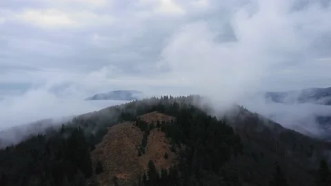 Mountain surrounded by low clouds Stock Footage 167667351