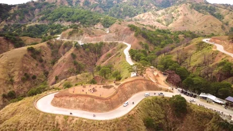 Mountain Switchback Road Surrounded by Scenic Hills Stock Footage 337783989