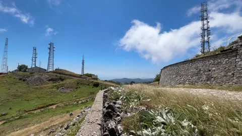 Mountain Telecommunication Towers with Windblown Grass and Fast Moving Clouds Stock Footage 341819580