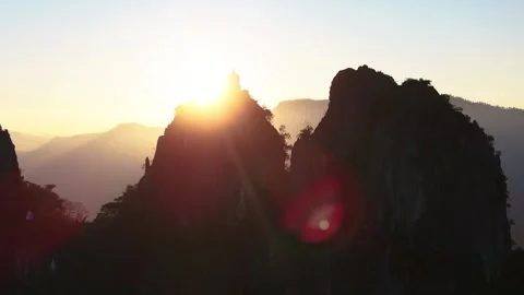 Mountain with temple and sunset in background, Wat Phra Phutthabat Sutthawat Stock Footage 330865796
