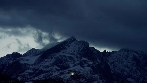 Mountain Time Lapse Featuring Shifting Dark Storm Clouds over Snowy Peaks Stock Footage 331166448