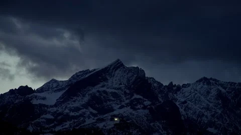 Mountain Time Lapse Featuring a Snowy Peak Under Dark Moving Storm Clouds Stock Footage 331166455