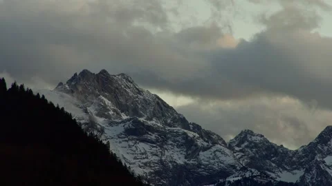 Mountain Time Lapse Shows Moving Clouds over Snowy Peaks and Pine Forests Vidéo 331166445