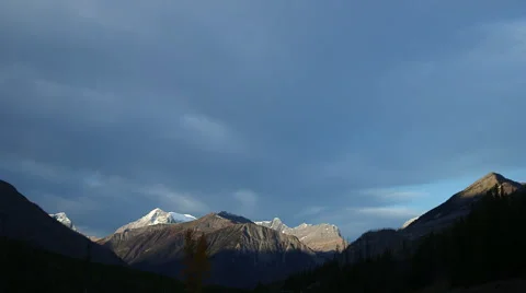 MOUNTAIN TIMELAPSE WITH NEGATIVE SPACE; SUNLIGHT REVEALS SNOW AND HILLSIDE Stock Footage 59069075