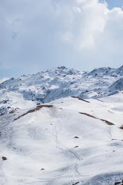 Mountain top covered by a thick layer of snow Stock Photos