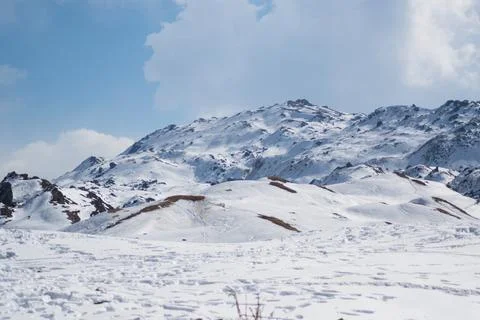 Mountain top covered by a thick layer of snow Stock Photos