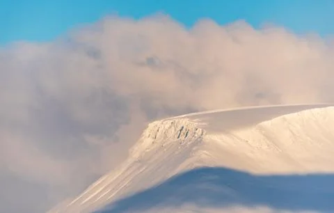 Mountain top emerges from cloud Stock Photos