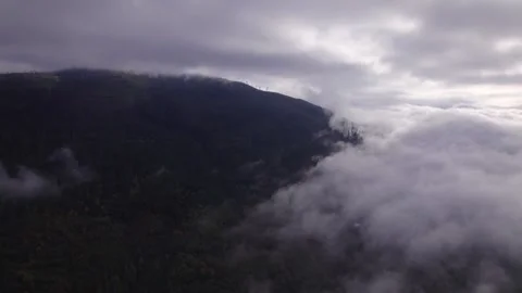Mountain top shrouded in clouds Stock Footage 253831890