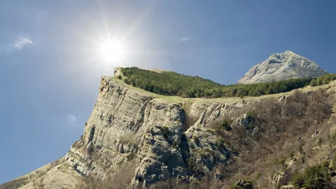 Mountain top under a hot sun  time lapse scene Stock Footage 252129611