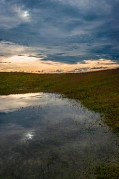 Mountain top view with bright sky and its reflection on water at morning from 写真素材