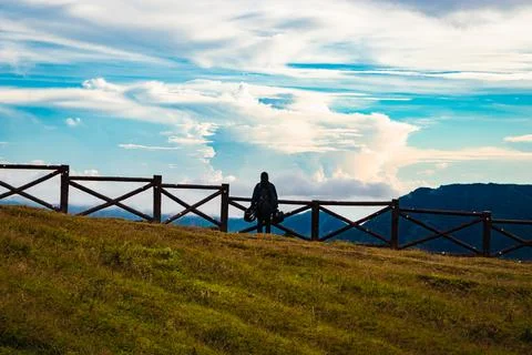 Mountain top view with dramatic sky and isolated girl at morning 스톡 사진