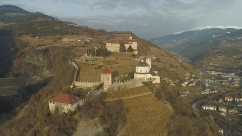 Mountain-top vineyard and Saben Abbey / Sabiona Monastery sunlit aerial in the Vídeos de archivo 129839853