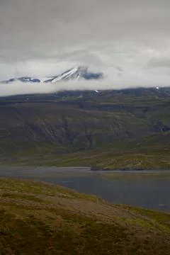 Mountain top wrapped in clouds Stock Photos