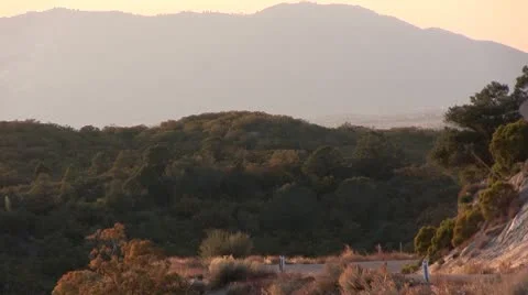 MOUNTAIN TRAFFIC AT SUNSET Stock Footage 10710907