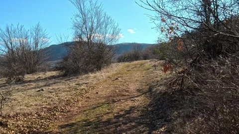 Mountain Trail Walk with Distant Hills View – 4K UHD Stock Footage Stock Footage 331873522