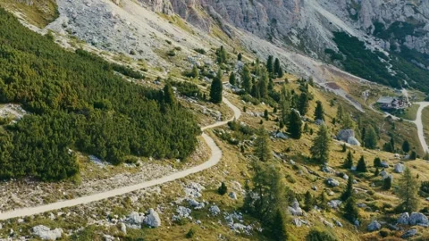 Mountain Trail Winding Through a Rocky Alpine Landscape at Golden Sunrise 库存影片 331165083