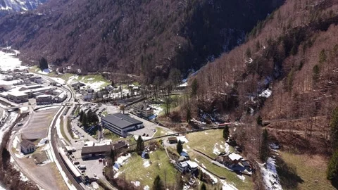 Mountain train exiting forest toward station 動画素材 332134660