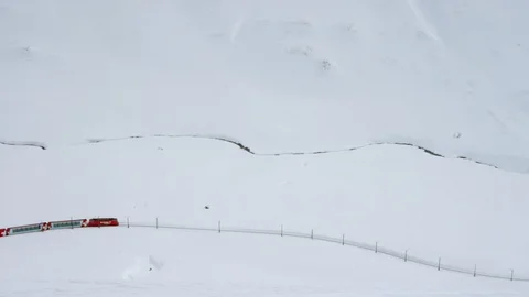 Mountain train moving downhill on snow covered mountain track Stock Footage 116742268