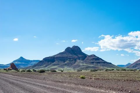 Mountain under blue cloudy sky, on the way from Khorixas to Palmwag Stock Photos