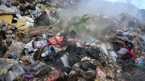Mountain of unsorted litter. A huge stinking pile of garbage rotting in a dump.  Stock Footage 146692032