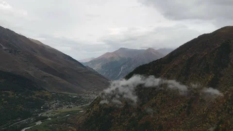 Mountain valley and clouds autumn timelapse drone shot Stock Footage 336482165