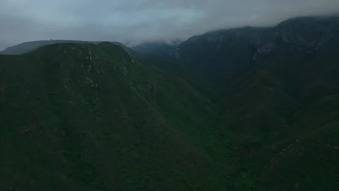 Mountain valley and dam under storm clouds, cinematic aerial Stock Footage 342395206
