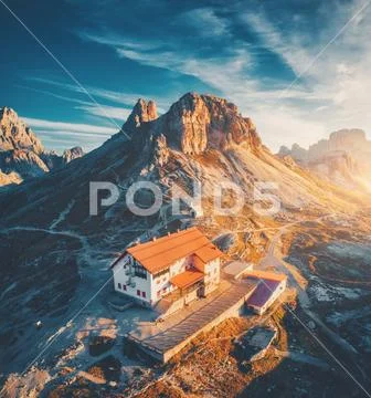 Mountain valley with beautiful house and church at sunset Stock Photos