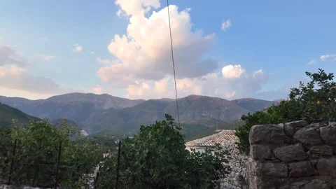 Mountain valley beyond grapevines rough stone wall, tiled roof large — Albania 库存影片 347670677