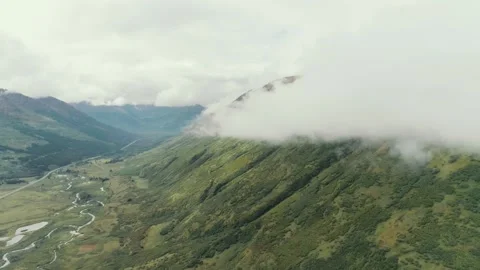 Mountain valley with clouds and winding river in daylight Stock Footage 320262906
