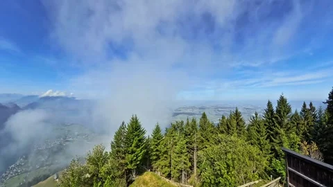 Mountain Valley Covered by Low Clouds Above Green Forest Stock Footage 343661382