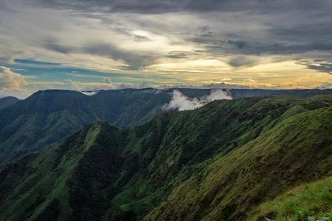 Mountain valley with dramatic sunset sky and low clouds at evening Foto stock