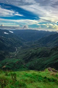 Mountain valley with dramatic sunset sky and low clouds at evening 스톡 사진