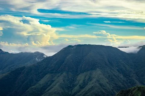 Mountain valley with dramatic sunset sky and low clouds at evening Stock Photos
