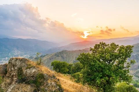 Mountain valley during sunset or sunrise. Natural spring or summer season l.. Stock Photos