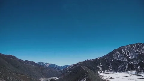 Mountain valley early spring: snow and a small mountain mound Stock Footage 75203318