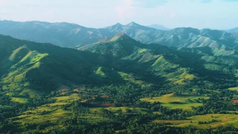 Mountain valley in the evening sun. Colorful hills with green meadow grass. Stock Footage 252107495