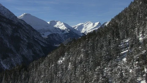 A mountain valley lies in the shadow and is surrounded by high peaks Stock Footage 101897605