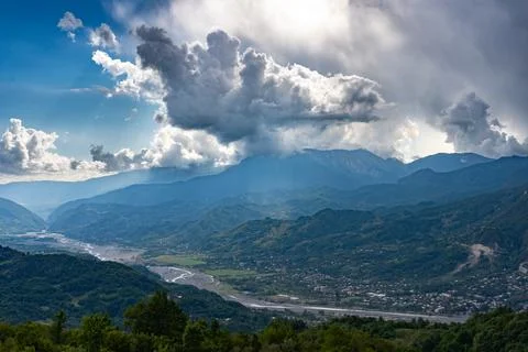Mountain valley panorama with thunderstorm clouds Stock Photos